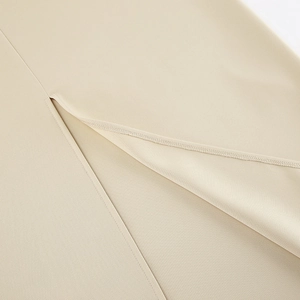 Detailed close-up of the professional overlock stitching on the dress side slit