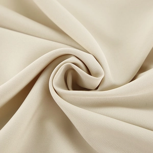 Macro shot of khaki irregular neck dress fabric showing soft draped texture and pleats
