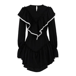 Detail of black flared sleeve dress featuring white lace trim and ruffle collar details