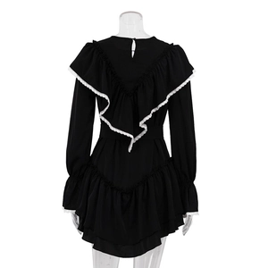 Detail of V-shaped ruffled back with white lace trim on a black long sleeve dress