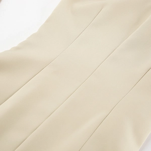 Macro detail of high-quality stitching and waist pleats on a khaki casual dress