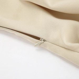 Detailed macro view of high-quality concealed zipper on khaki fabric dress seam