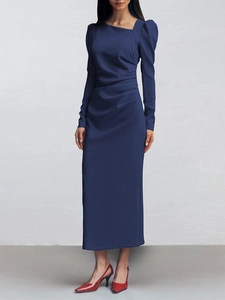 Detail of navy blue slit dress with asymmetric neckline, puff sleeves and pleated waist