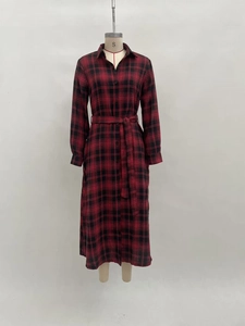 Close-up of red and black plaid shirt dress featuring a classic collar and button closure