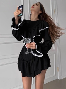 Elegant black mini dress with white ruffled lace trim and long bell sleeves