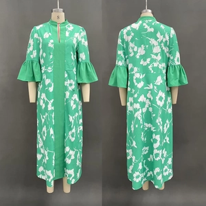 Detail of green floral maxi dress with puff sleeves and ruffled cuffs on a mannequin