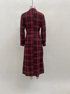 Detail view of the red and black plaid dress back with waist belt and long sleeves
