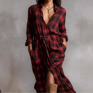 Detail shot of long-sleeved red plaid shirt dress featuring waist tie and side slits