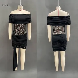 Detail view of black off-shoulder dress with lace patchwork and ruched mesh texture