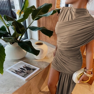 Detail of khaki sleeveless ruched dress showing the intricate pleated texture and slim fit