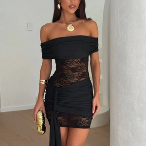 Close-up of elegant floral lace stitching and ruched side detail on a black bodycon dress