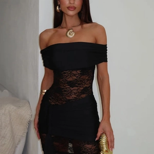 Close-up of black off-shoulder dress with intricate floral lace stitching and stretchy mesh