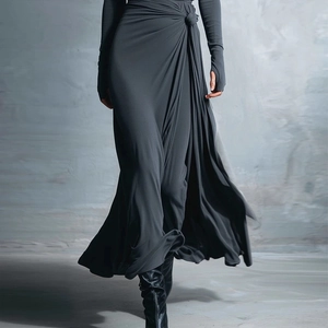 Detail view of dark grey wrap dress showing knot-twist waist and soft knit fabric texture