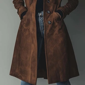 Detail of premium brown suede texture and button closure on long trench coat