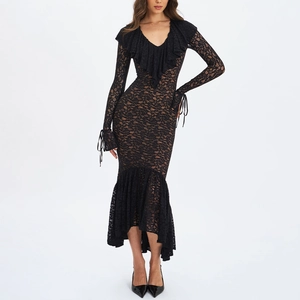 Detailed close-up of intricate black floral lace pattern and ruffle trim on the V-neck dress