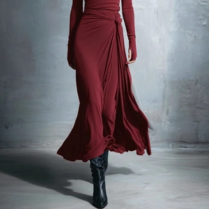 Detail of burgundy wrap dress featuring a knotted waist and elegant side slit