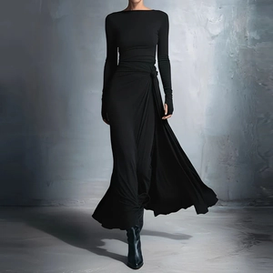 Detail of waist knot and side slit on an elegant black off-shoulder long sleeve dress