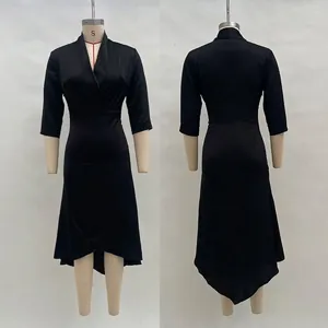 Detail of elegant black V-neck satin midi dress with asymmetrical hem and long sleeves