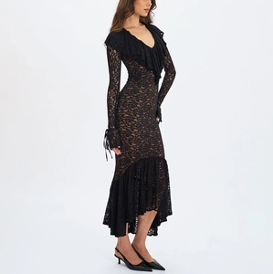 Detailed close-up of black lace floral texture and ruffled V-neckline of this elegant dress