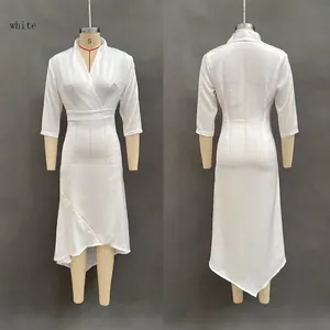 Detail view of white satin wrap dress featuring deep V-neck and asymmetrical ruffle hem