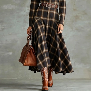 Detail of vintage plaid dress with brown leather belt and western cowboy boots