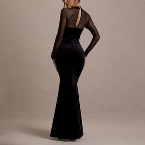 Back view of a black velvet mermaid gown with sheer mesh panels and cut-out detail