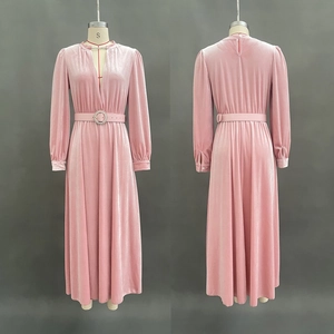 Detail view of pink velvet dress with rhinestone buckle belt and V-neckline texture