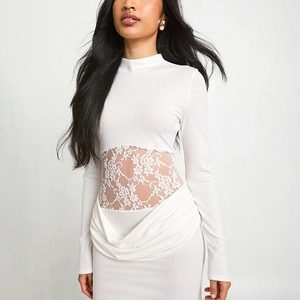 Close-up of elegant lace patchwork and draped details on white bodycon dress