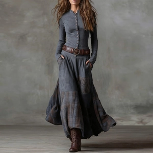 Detail view of the vintage patchwork plaid hem on a long-sleeved retro maxi dress