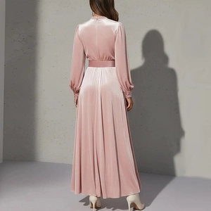 Detail view of pink velvet dress back showing waist belt and luxurious fabric texture