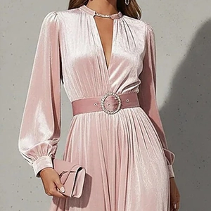 Detail of pink velvet dress featuring V-neckline and elegant waist belt with rhinestone buckle