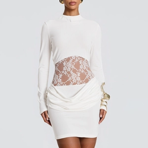 Detail of white mini dress featuring lace patchwork waist and elegant ruched styling