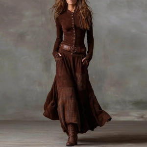 Detailed view of brown vintage dress featuring patchwork hem and wide leather belt
