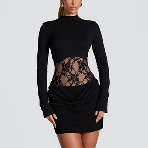 Detail of floral lace patchwork on a slim black long-sleeved mini dress for party wear