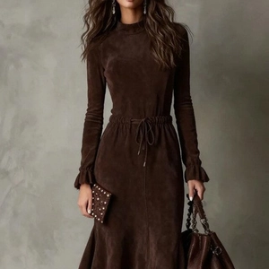 Detail of dark brown suede dress featuring tie-waist drawstring and ruffled cuffs