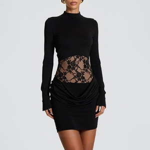Close-up of black bodycon dress featuring intricate floral lace waist cutout and ruched hem