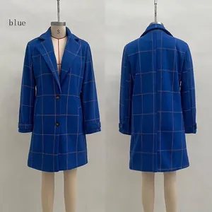 Detail of blue plaid wool coat featuring notch lapels and decorative cuff straps