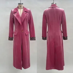 Detailed view of pink velvet long coat featuring notched lapels and leopard print cuffs