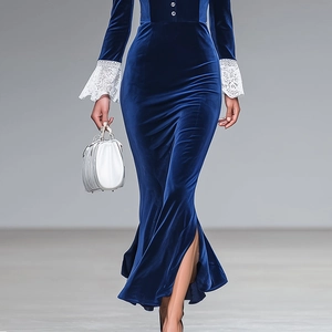 Detail of elegant dark blue velvet dress featuring lace cuffs and side slit hemline