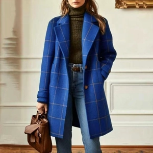 Detail shot of the blue plaid wool coat featuring a classic lapel and textured fabric