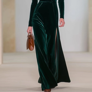 Detail of elegant dark green velvet dress featuring a slim fit and a high side split cut