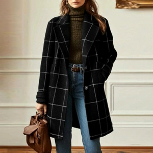 Detailed view of women's black plaid wool coat with lapel collar and button closure