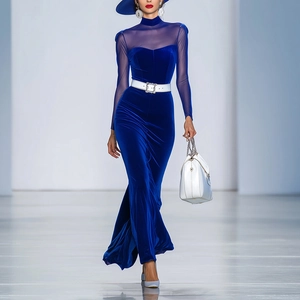 Detail of navy velvet dress featuring sheer mesh sleeves and white belt with rhinestone buckle