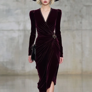 Detailed view of burgundy velvet dress featuring elegant V-neck with black lace trim