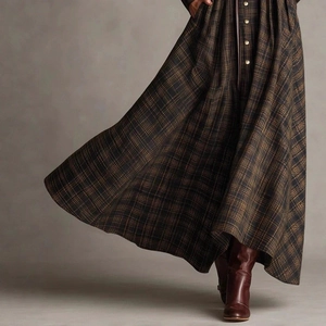 Detailed shot of pleated vintage plaid maxi dress with gold buttons and flowy hemline