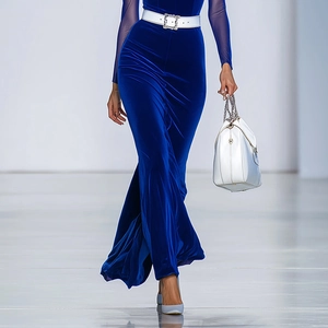 Close-up of royal blue velvet dress with a white belt featuring a crystal buckle