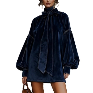 Detail of navy velvet mini dress showing lantern sleeves and contrast white stitching