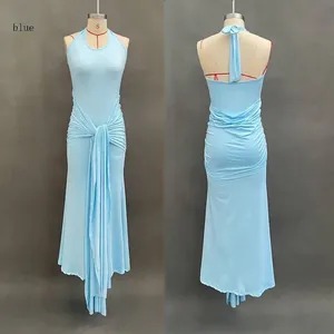 Detail of light blue backless maxi dress featuring waist pleats and elegant long ribbons
