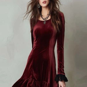 Detail view of burgundy velvet dress with black lace sleeves and elegant ruffle hemline
