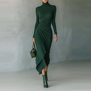Detail of dark green knit dress featuring elegant waist draping and pleated design